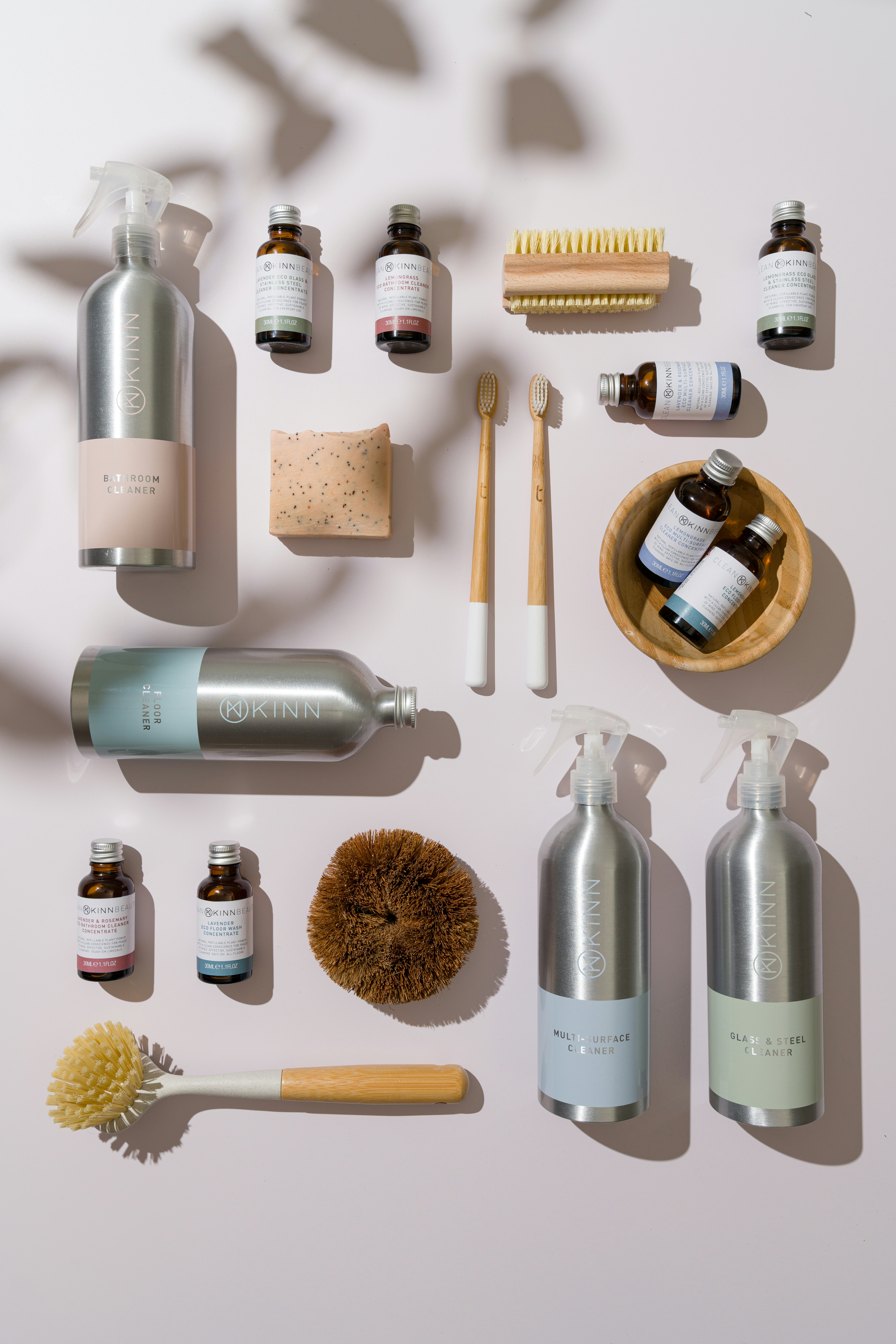 A flat-lay of spray bottles, brushes and eco-friendly cleaning products